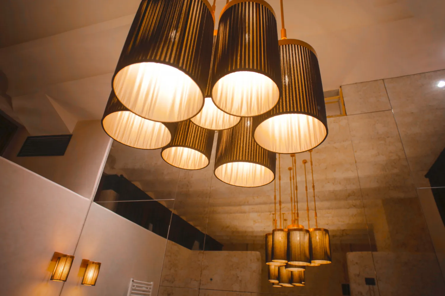 Cluster of decorative pendant lights with warm fabric shades